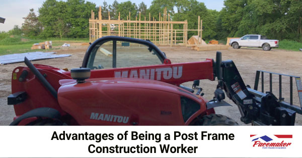 Red earthmover in foreground of post frame construction site. a