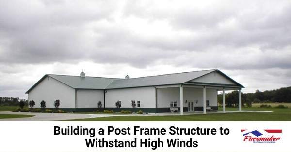 Post frame building shown with storm clouds.